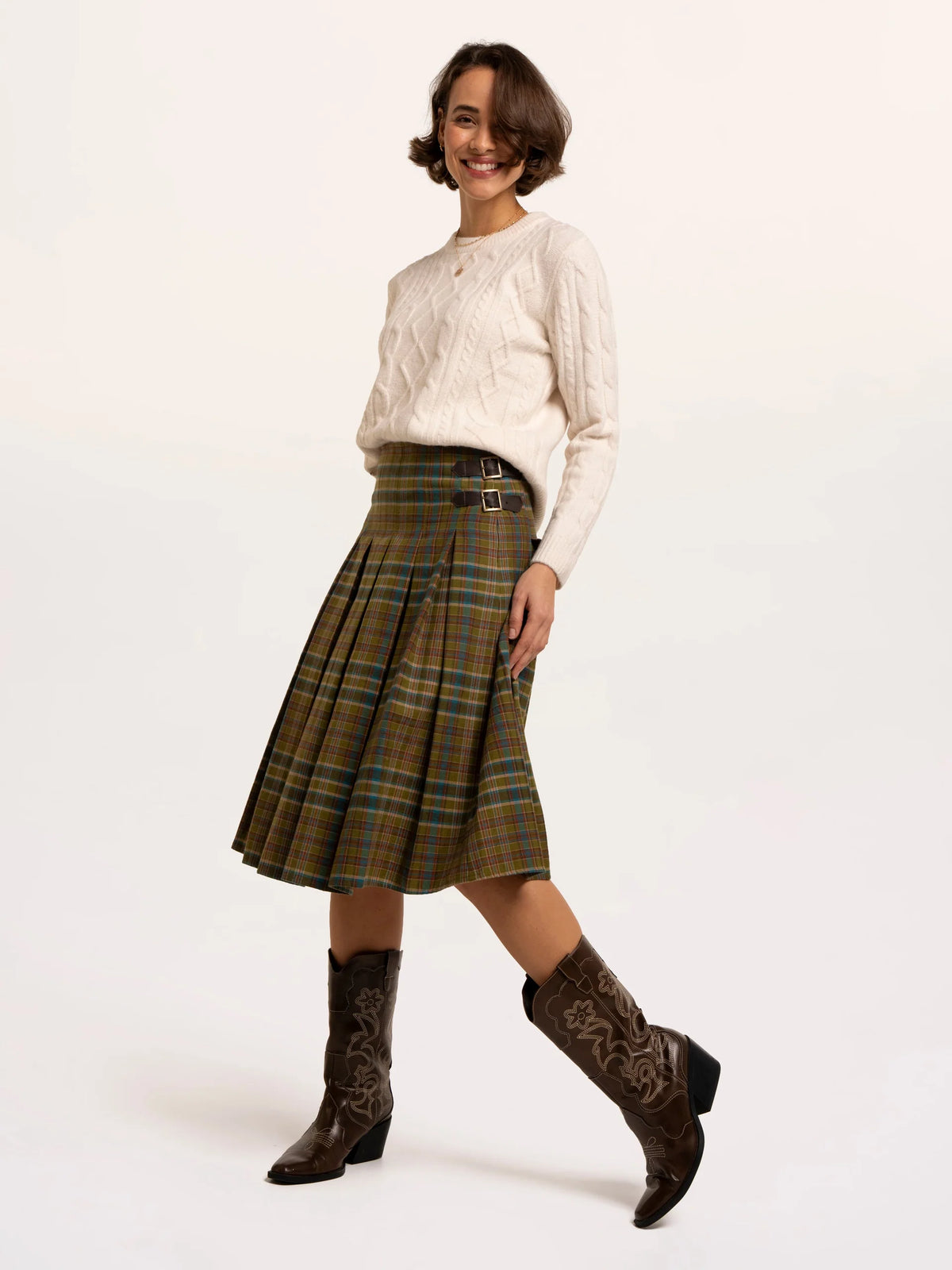 Brakeburn Red Cedar Check Pleated Kilt Skirt styled with a cream cable knit jumper and brown boots