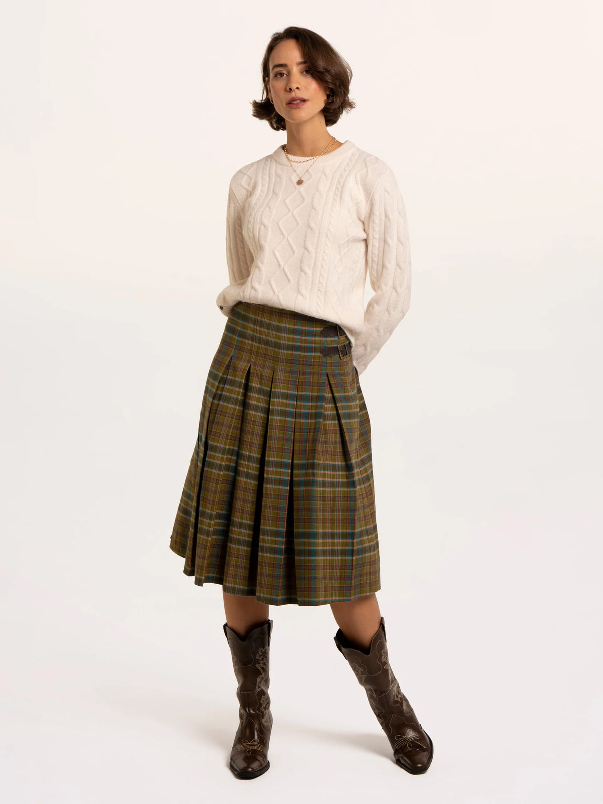 Brakeburn Red Cedar Check Pleated Kilt Skirt styled with a cream cable knit jumper and brown boots