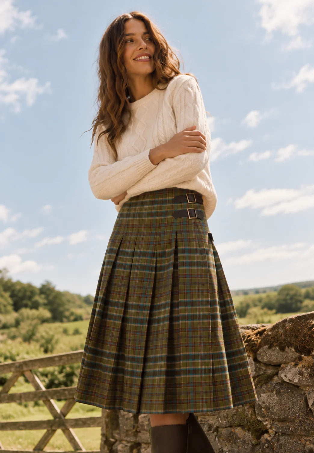 Brakeburn Red Cedar Check Pleated Kilt Skirt styled with a cream cable knit jumper and brown boots