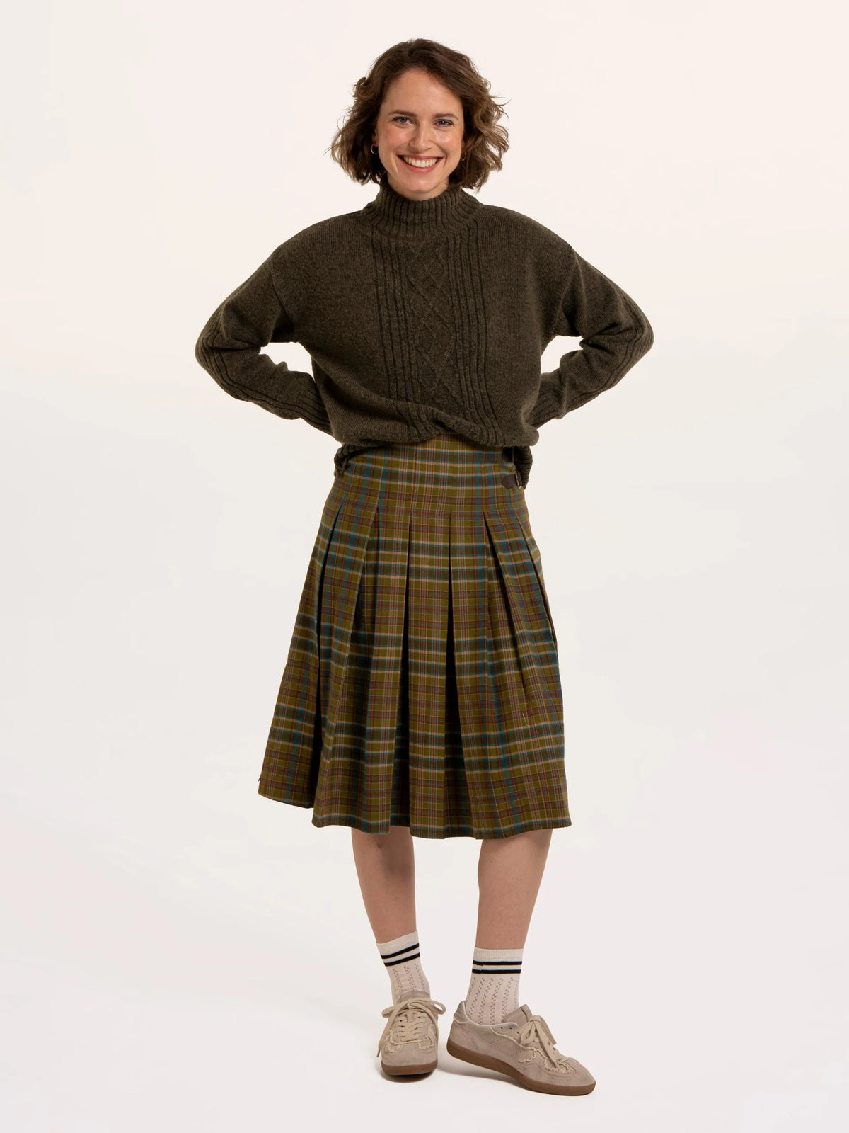 Brakeburn Signe Stitch Detail Knitted Roll Neck Jumper in olive green styled with burgundy corduroy trousers