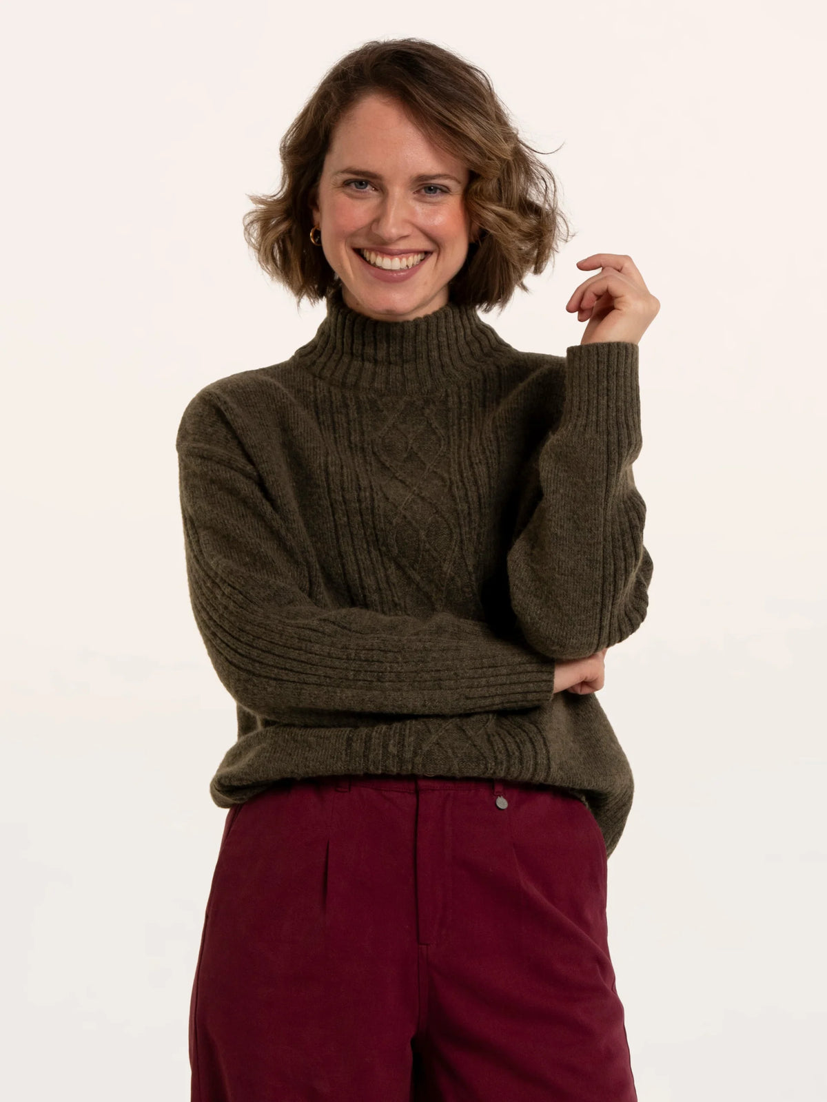 Brakeburn Signe Stitch Detail Knitted Roll Neck Jumper in olive green styled with burgundy corduroy trousers