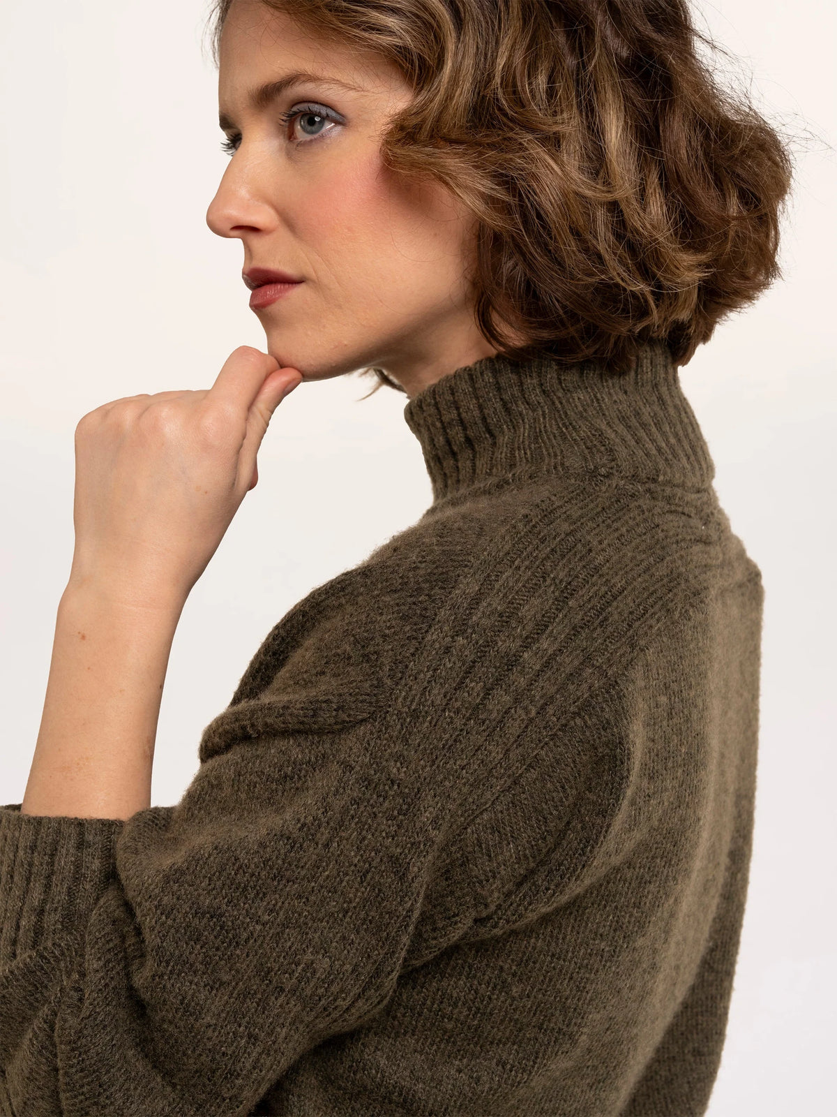 Brakeburn Signe Stitch Detail Knitted Roll Neck Jumper in olive green styled with burgundy corduroy trousers