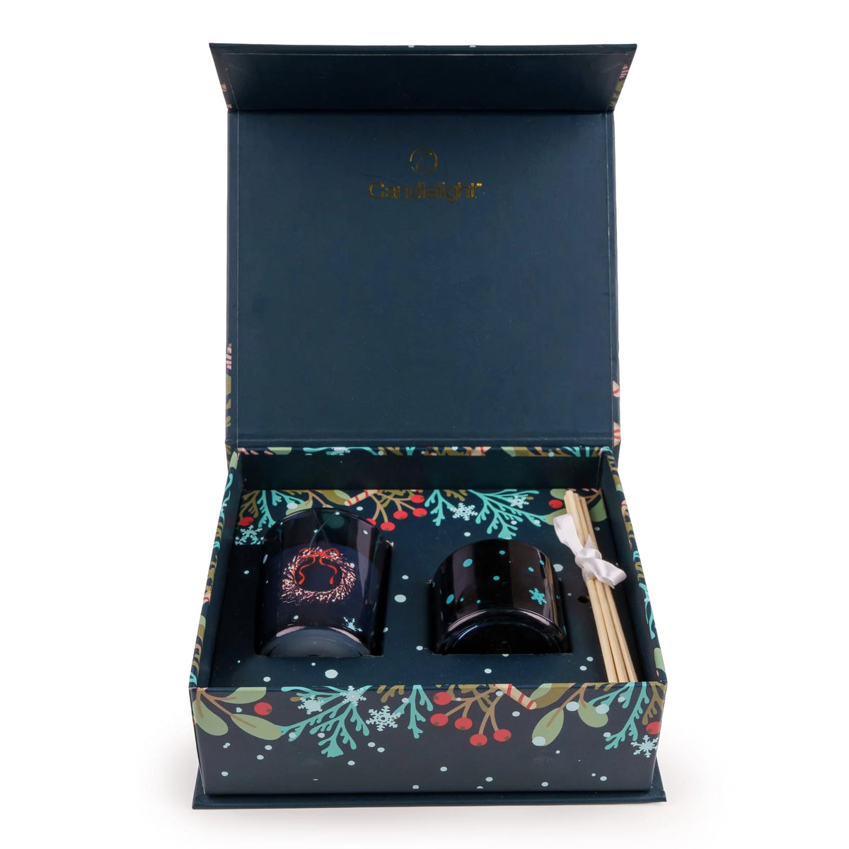 Candlelight Trees in Blue festive fragrance gift set featuring a deep blue glass candle and reed diffuser inside a dark blue decorated box