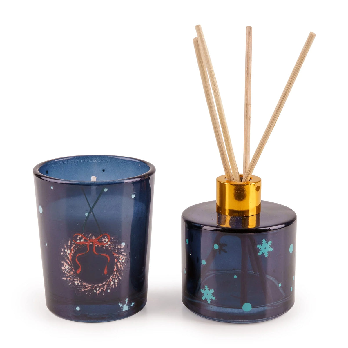 Candlelight Trees in Blue festive fragrance gift set featuring a deep blue glass candle and reed diffuser inside a dark blue decorated box