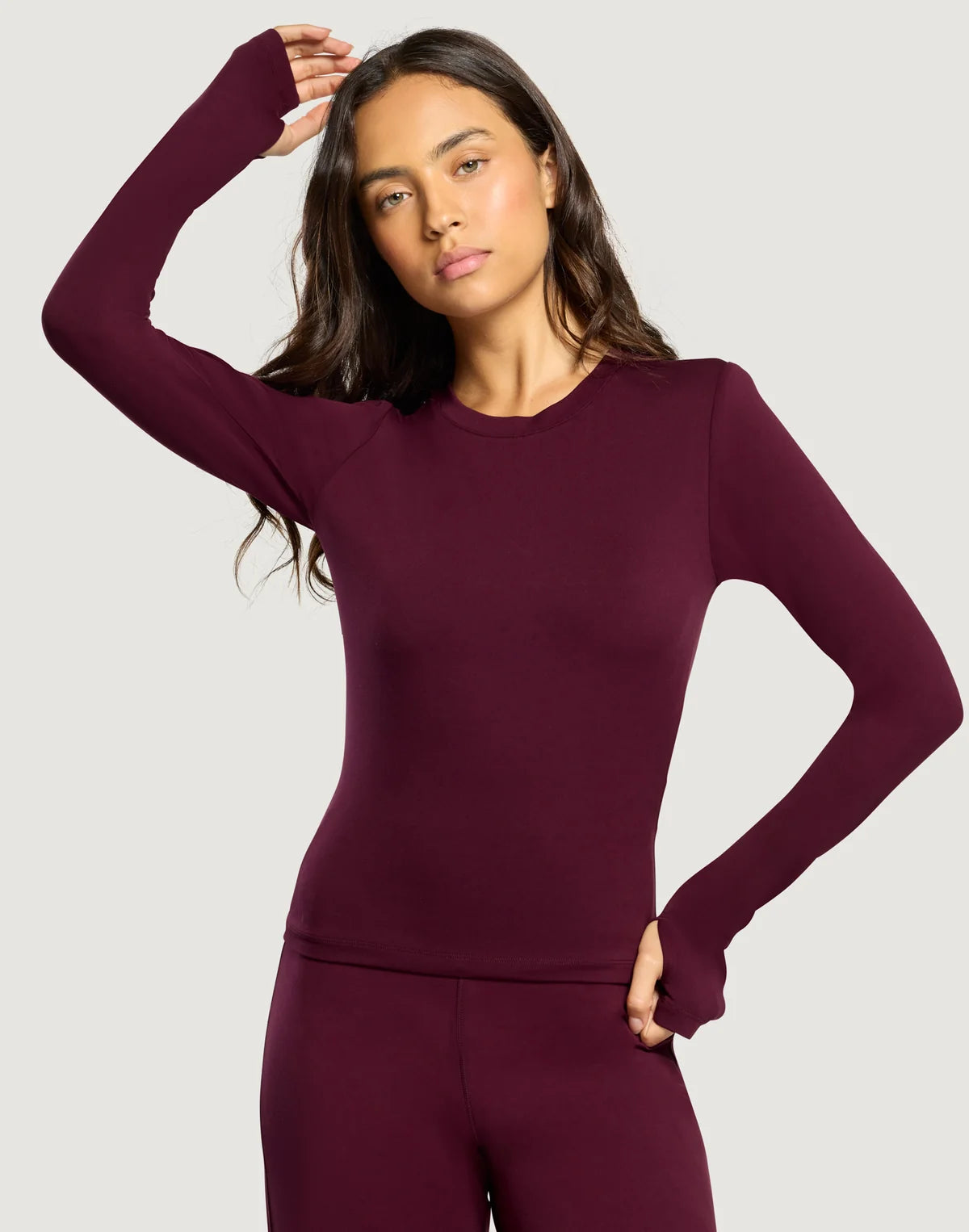 Front view of the Gym + Coffee Day Kind Long Sleeve Activewear Layer featuring a slim fit and thumbholes in Cherry Crush.