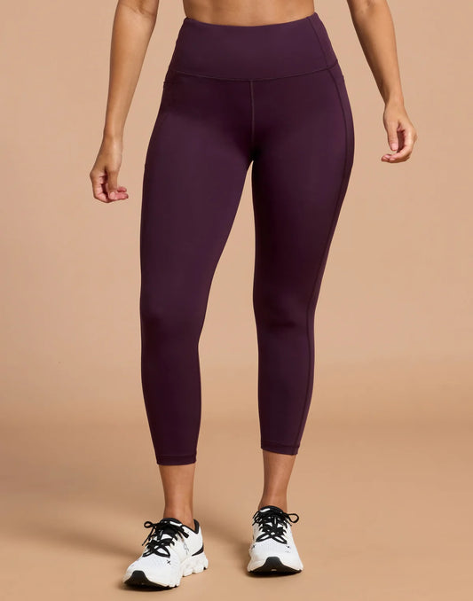 Front view of the Gym + Coffee Relentless 7/8 Leggings featuring a high-rise waistband and side pockets in Grape Noir.