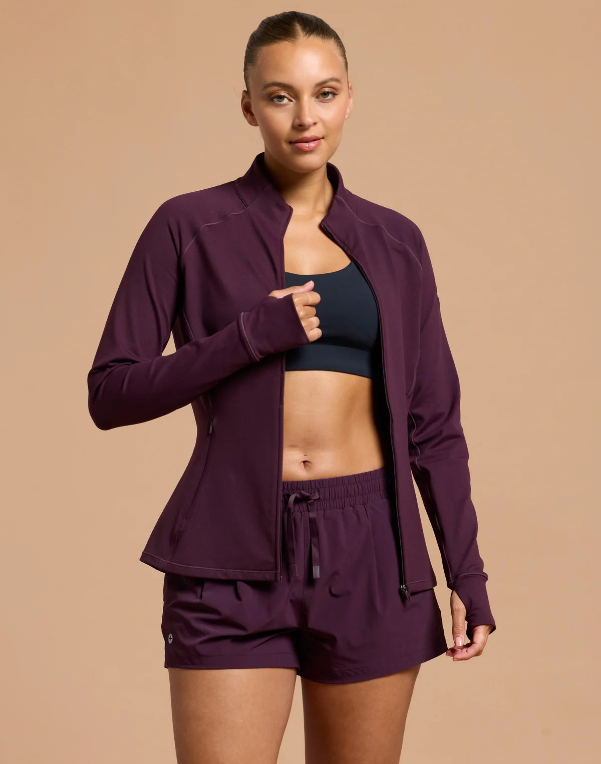 Front view of the Gym + Coffee Relentless Full Zip Midlayer featuring a streamlined athletic fit and full zip closure.