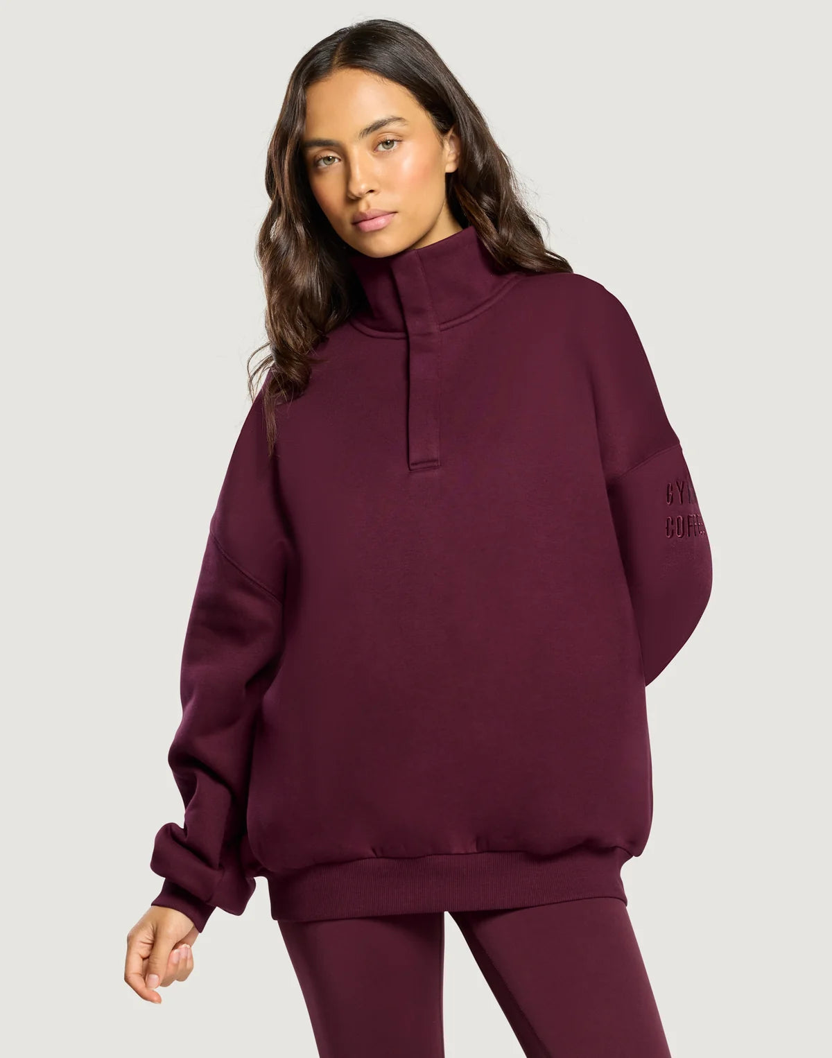 Front view of the Gym + Coffee Snap Collar Sierra Sweatshirt featuring a snap-button collar and a relaxed oversized fit in Cherry Crush.
