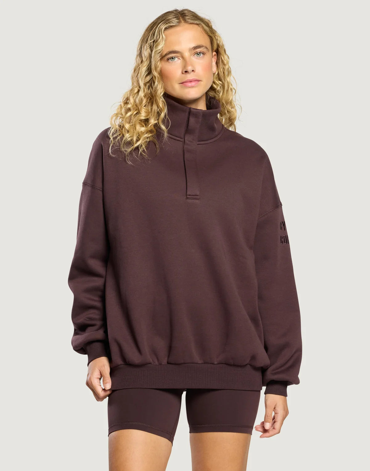 Front view of the Gym + Coffee Snap Collar Sierra Sweatshirt featuring a snap-button collar and a relaxed oversized fit in Mocha Bean.