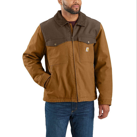 A man wearing a brown and tan Carhartt work jacket with blue jeans, shown from the waist up against a plain white background.