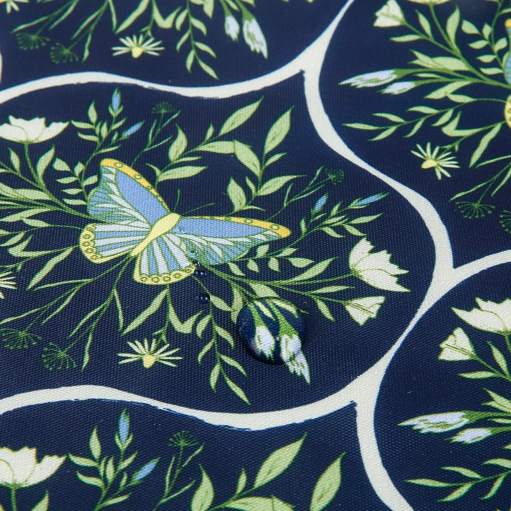 Eco Chic lightweight foldable reusable shopping bag featuring blue butterflies and botanical trellis pattern on navy fabric