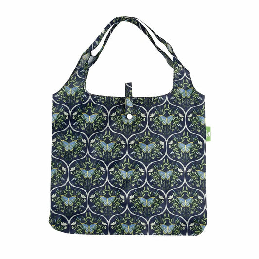 Eco Chic lightweight foldable reusable shopping bag featuring blue butterflies and botanical trellis pattern on navy fabric
