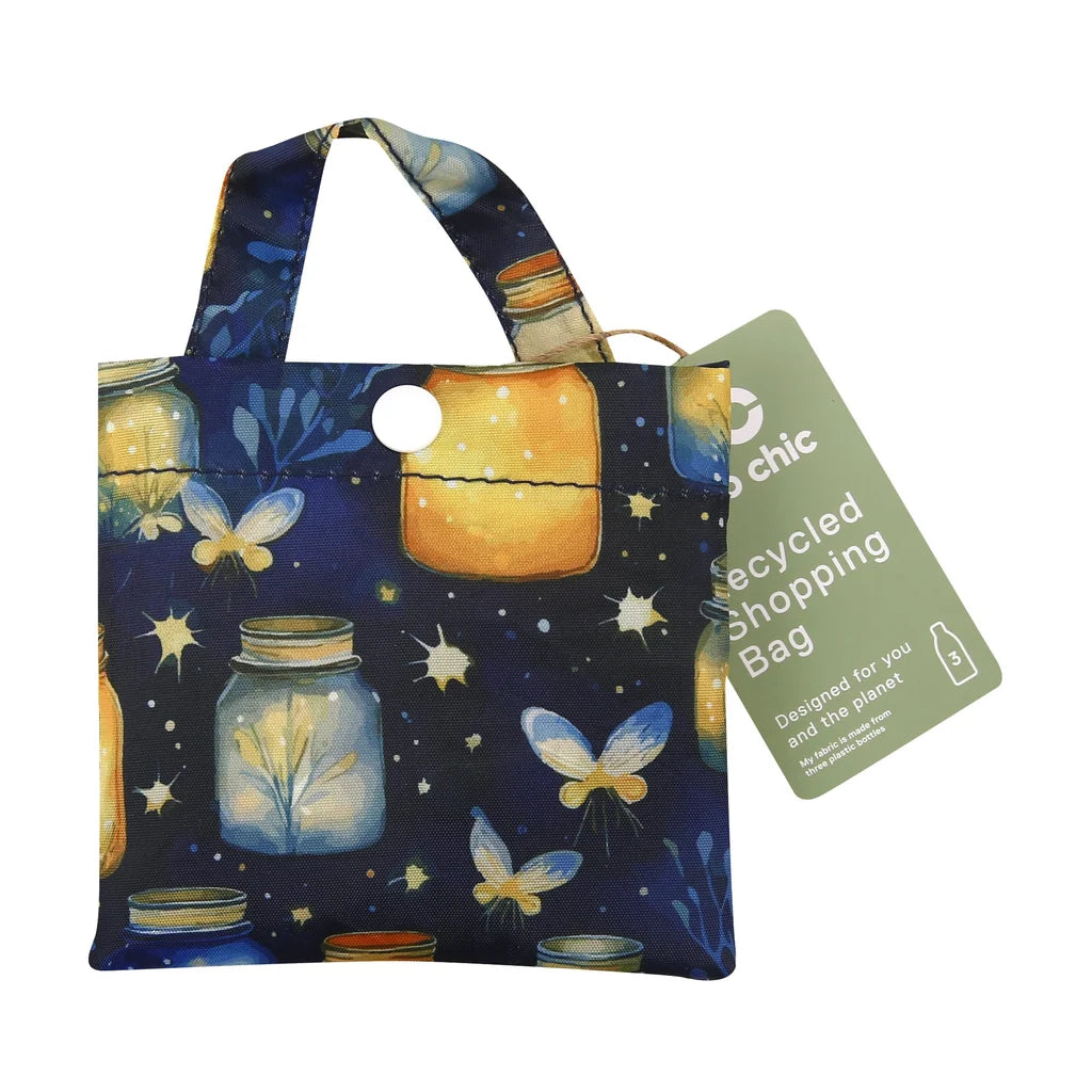 Eco Chic lightweight foldable reusable shopping bag featuring glowing jars and fireflies pattern on navy blue fabric