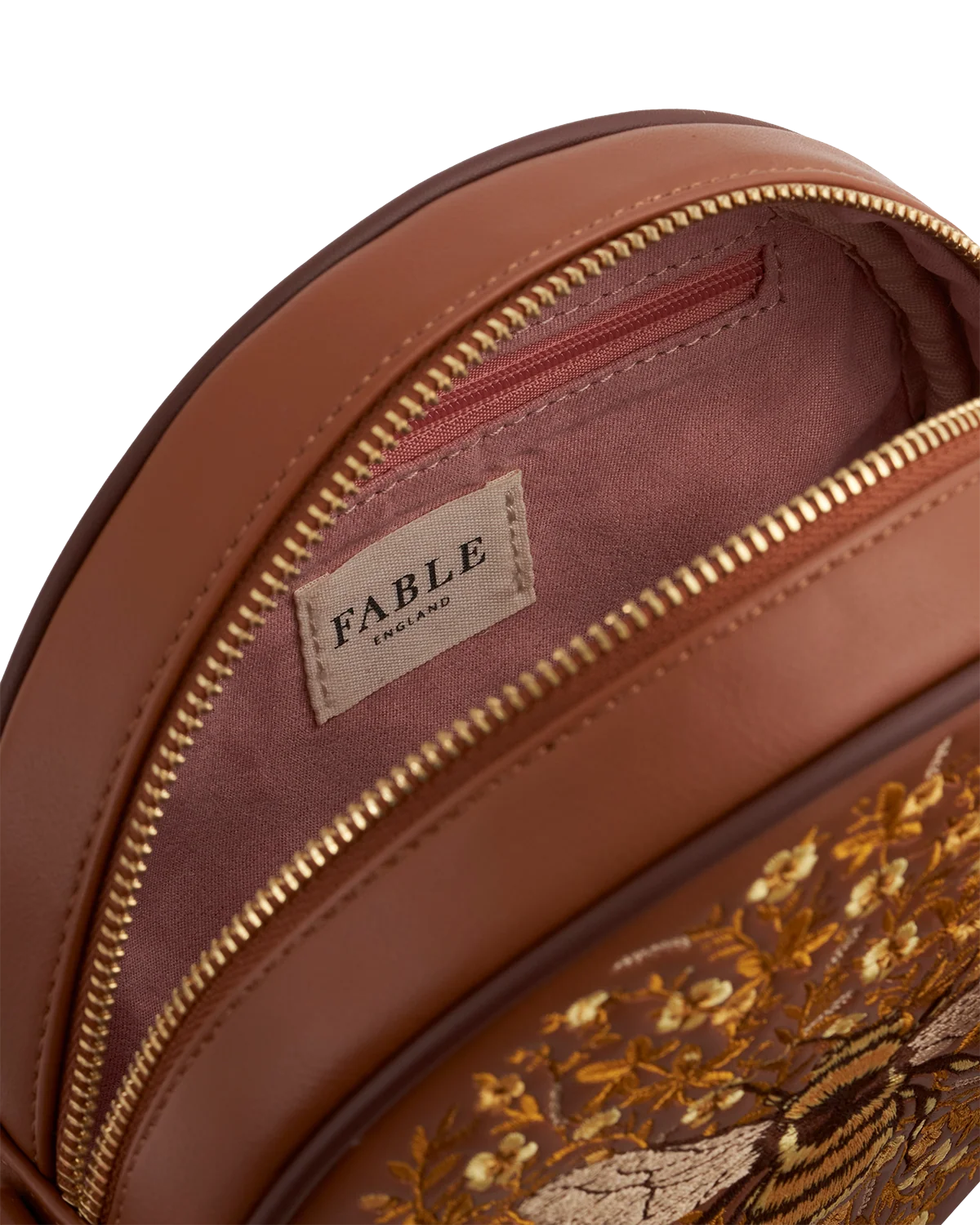 Fable Bumble Circle Bag in tan faux leather featuring detailed embroidered bee and floral pattern