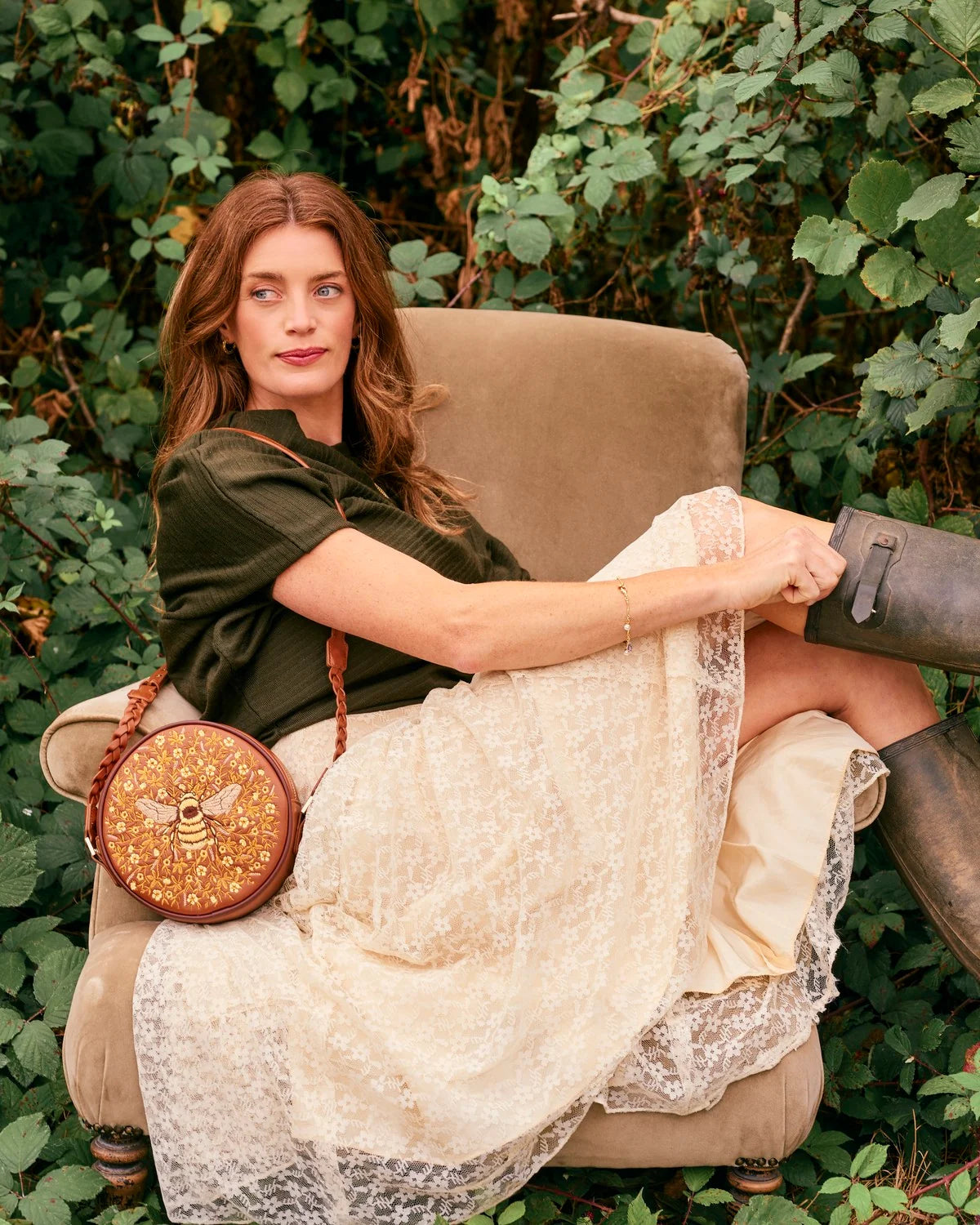 Fable Bumble Circle Bag in tan faux leather featuring detailed embroidered bee and floral pattern