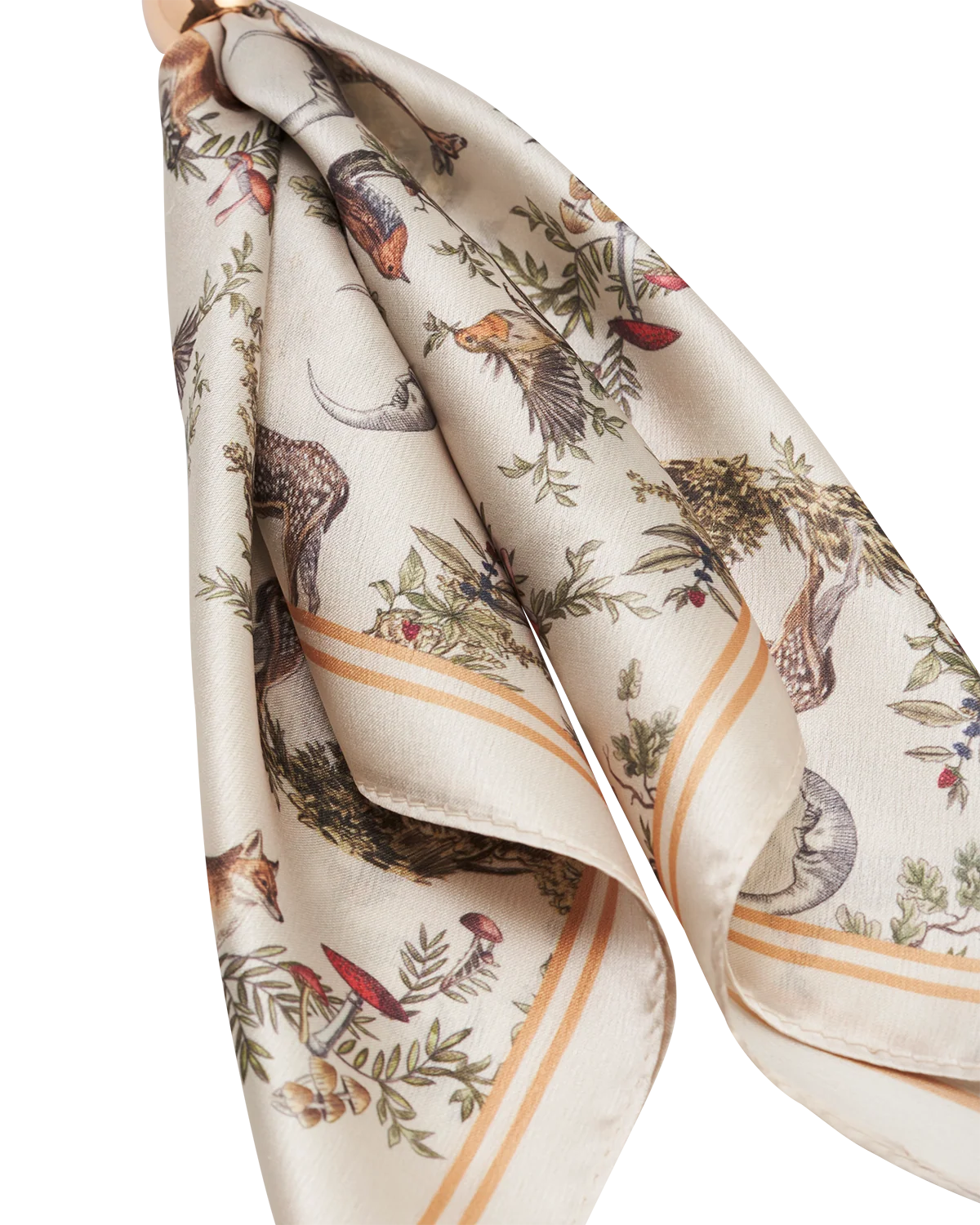 Fable Into the Woods Scarf Bag Charm attached to a brown leather handbag showing gold clip and printed scarf