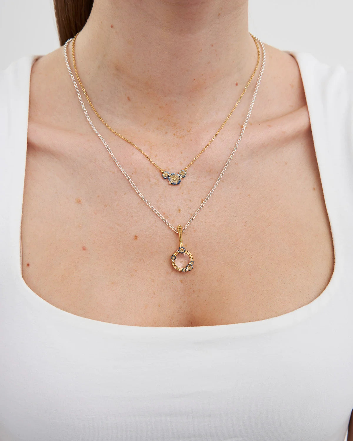 Fable Larkspur Magnifying Glass Necklace in Gold featuring hand-painted larkspur flowers and white CZ stones