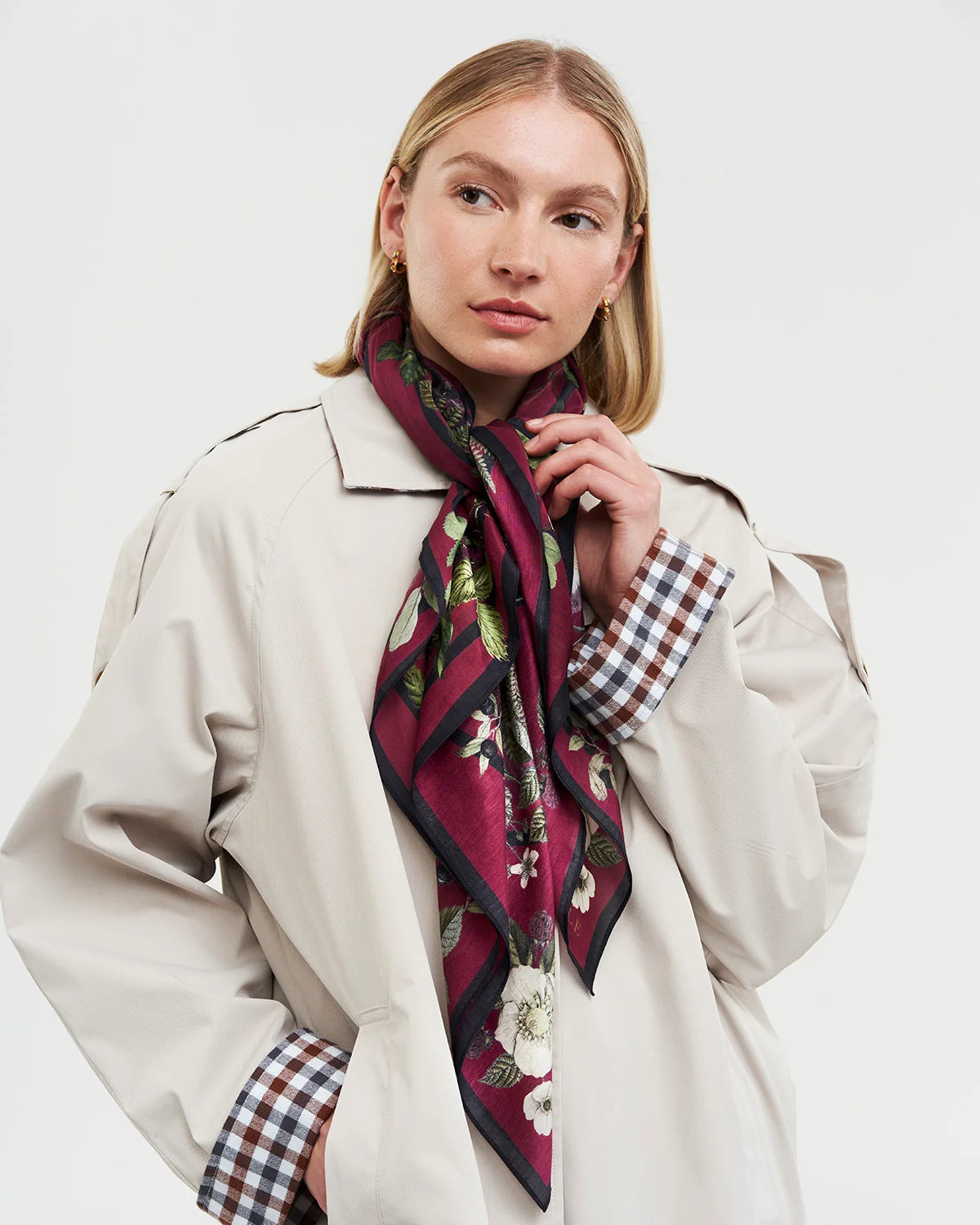 Fable Orla Narrative Medium Square Scarf in Burgundy with illustrated woodland print tied around model neck