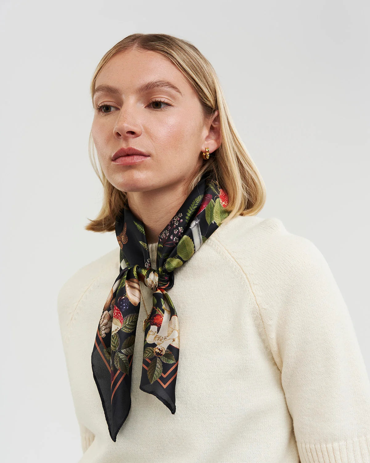 Orla Square Scarf in burgundy featuring woodland animal and mushroom print tied around model's neck