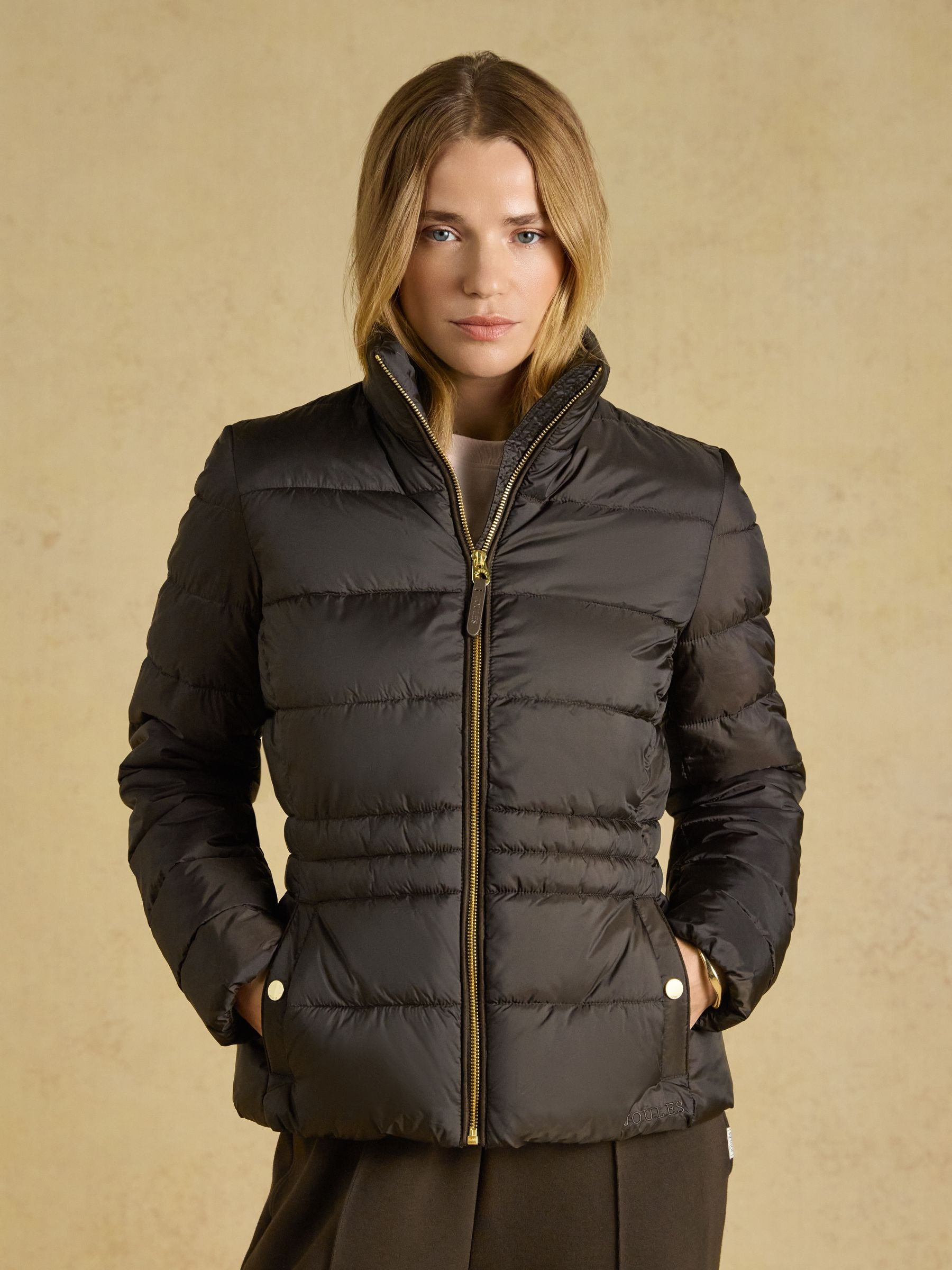 Joules Paddock Showerproof Padded Coat in a contoured tailored fit showing suedette piping and high collar.