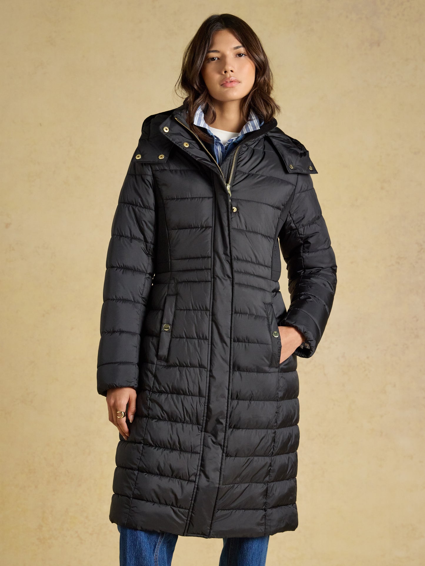 Woman wearing the Joules Windborough Showerproof Longline Padded Coat with Hood in a tailored fit
