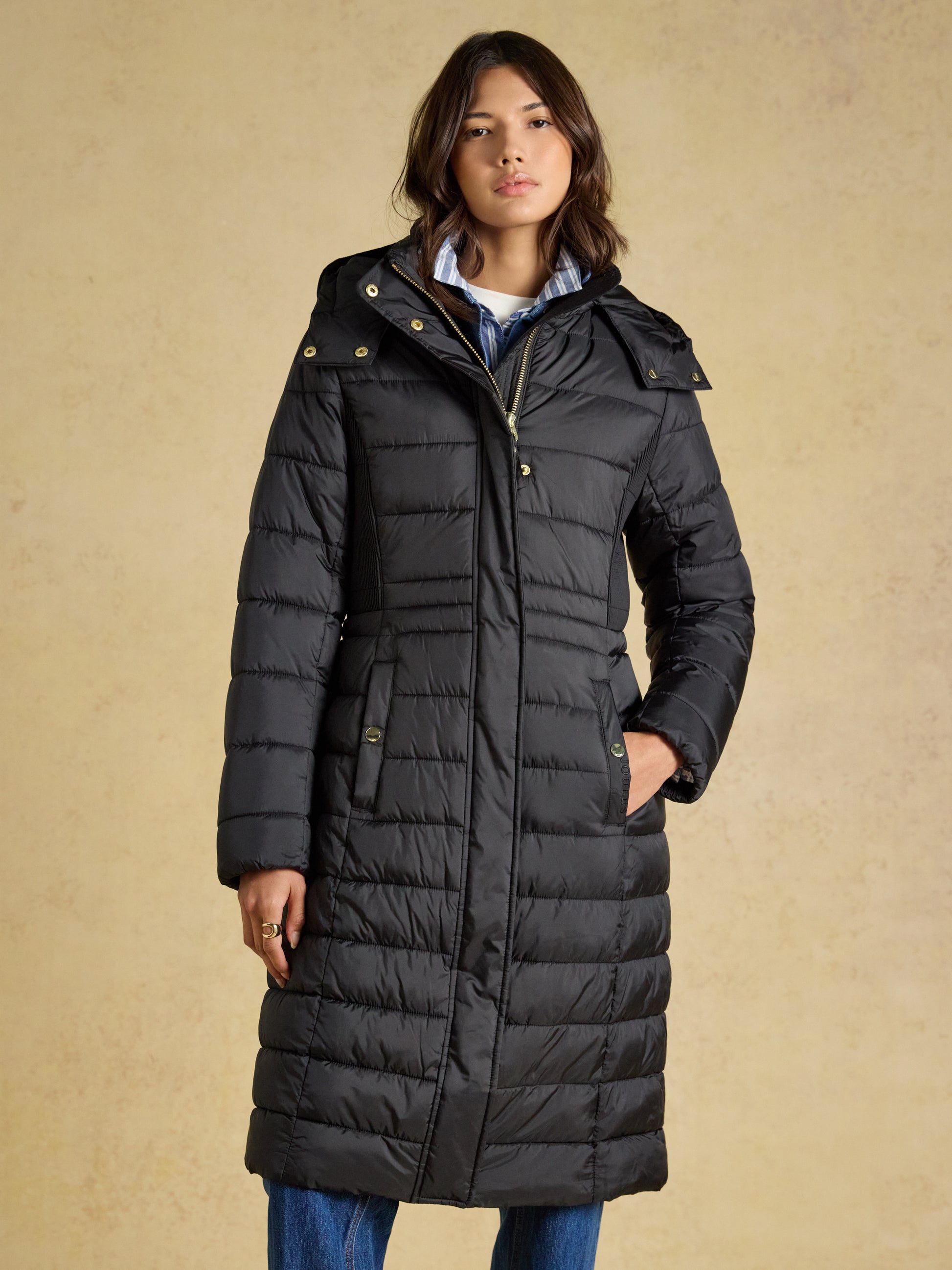 Woman wearing the Joules Windborough Showerproof Longline Padded Coat with Hood in a tailored fit