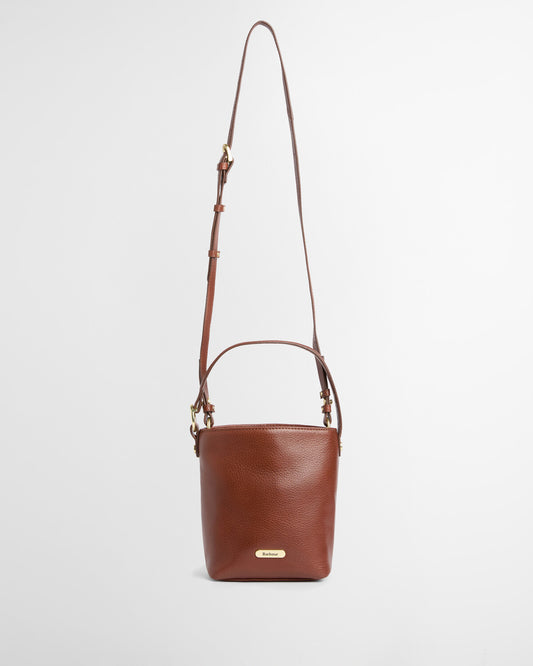 Barbour Cedar Mini Leather Bucket Bag in premium bovine leather featuring a top grab handle, detachable strap, and matte gold logo badge.