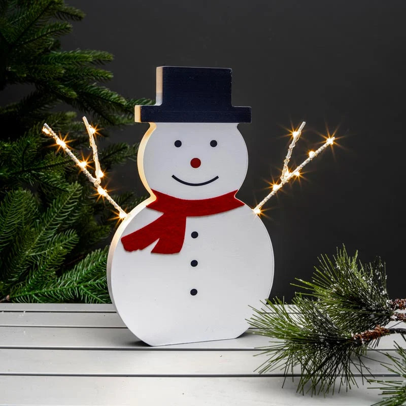Brighten your indoor holiday home with the NOMA 30cm Wooden Snowman decoration. Features 14 warm white micro wire LEDs and battery operation.