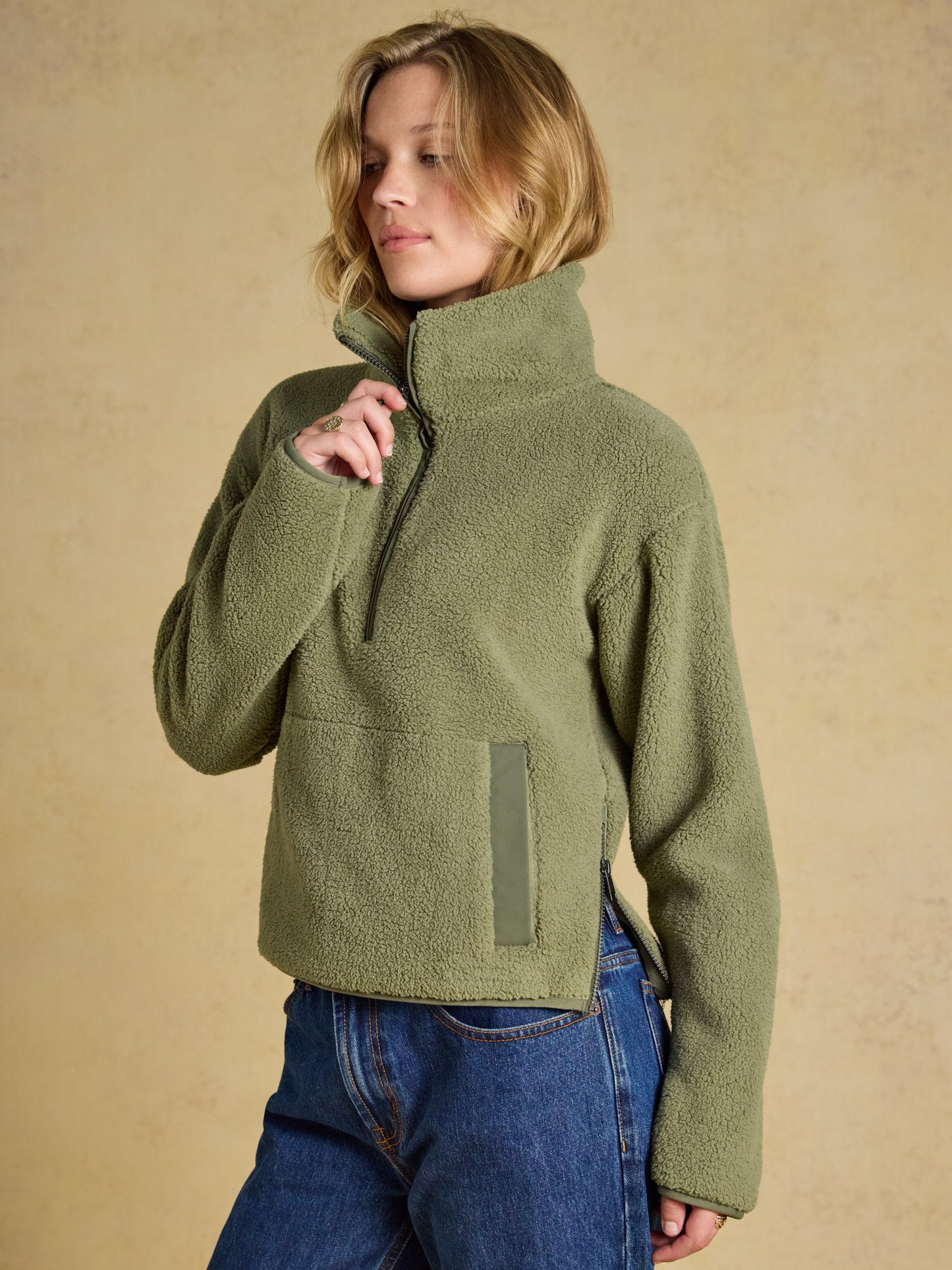 Woman wearing the Joules Cropped Quarter Zip Fleece in an ultra-plush insulating material with a funnel neck