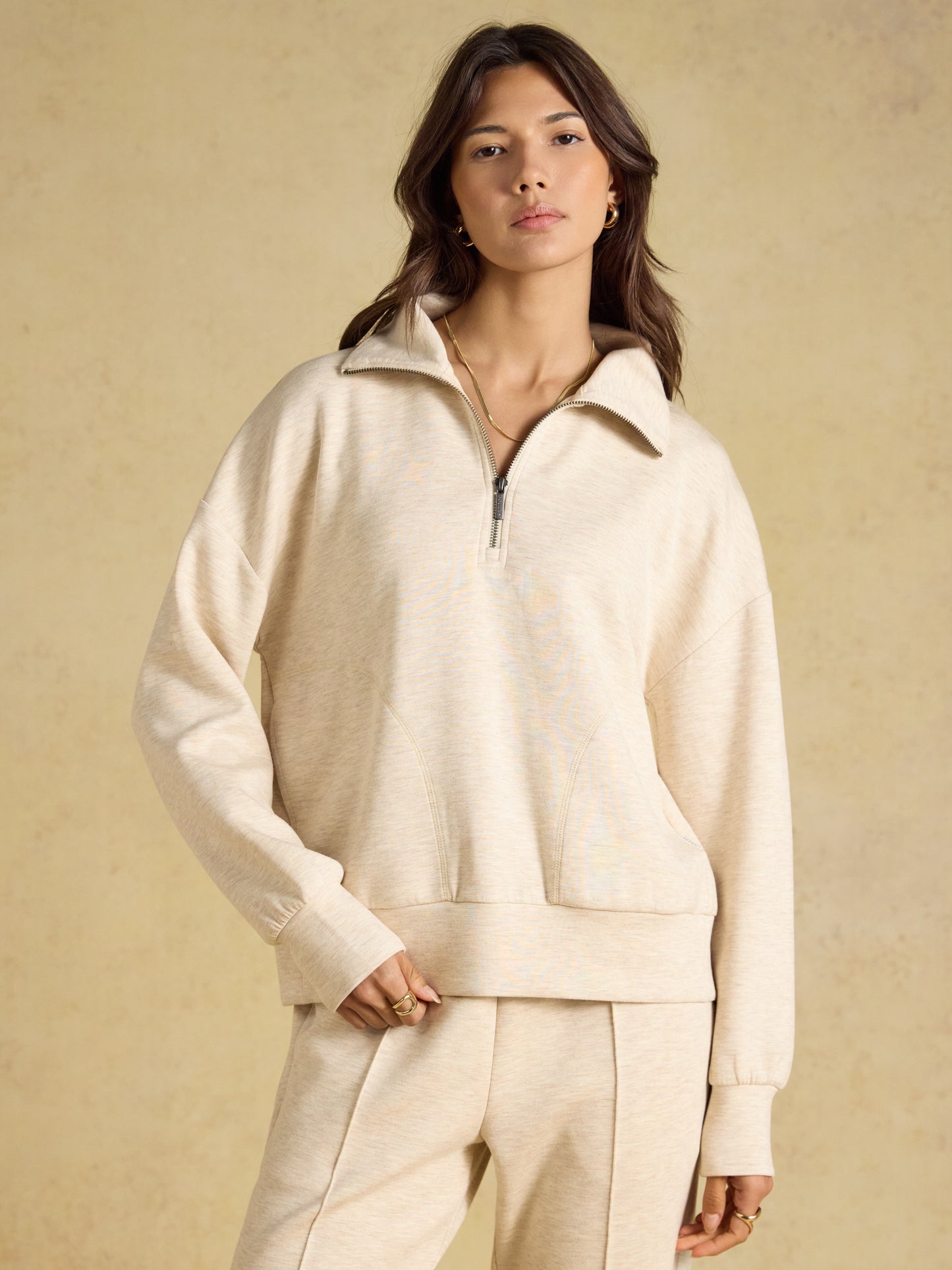 Joules soft women's quarter zip sweatshirt in a relaxed boxy fit featuring a drawstring hood and front pockets.
