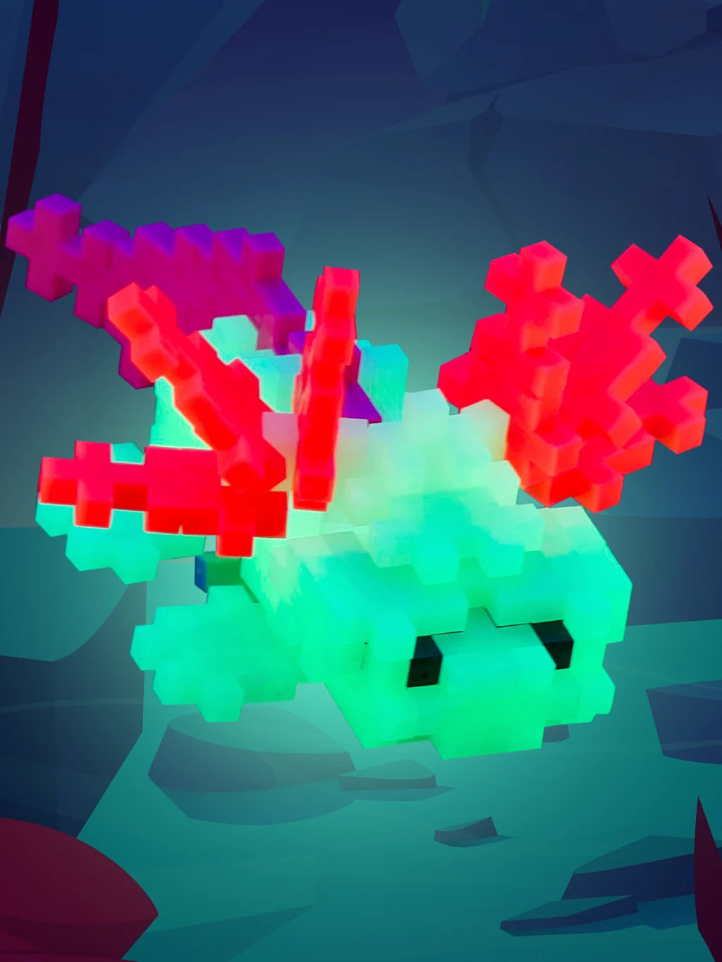 Plus-Plus Axolotl tube packaging alongside a constructed glow-in-the-dark axolotl figure made from interlocking pieces.