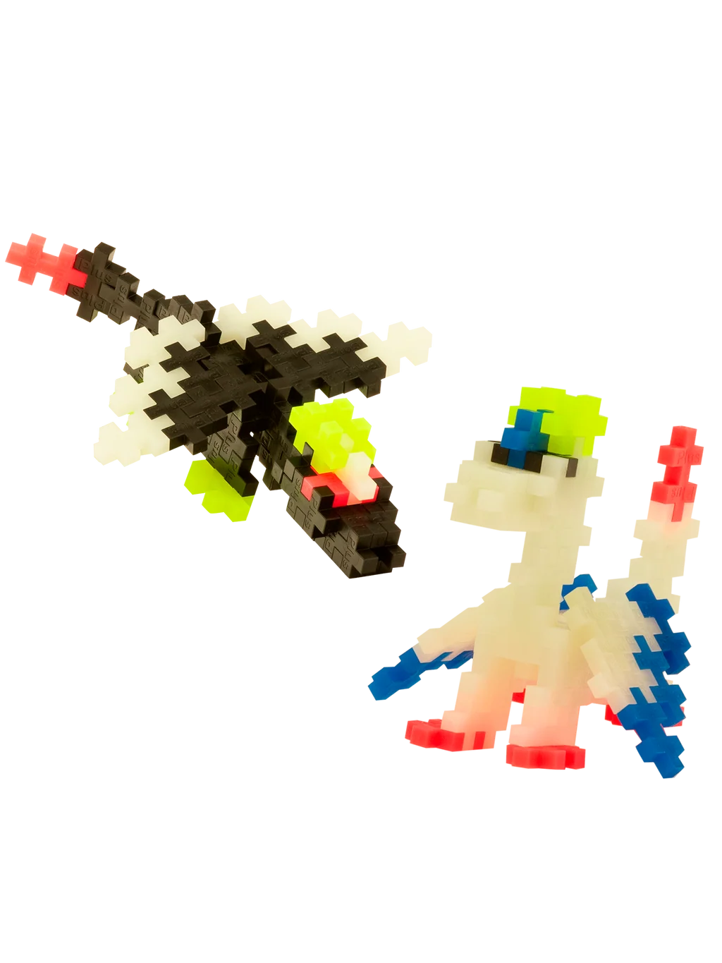 Plus-Plus Glow Dragons clear tube container displayed with built black and white glow-in-the-dark toy dragon figures.