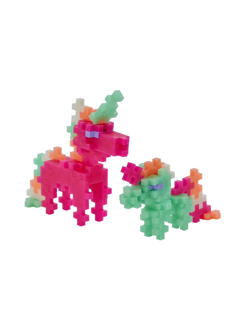 Plus-Plus Pearl Unicorns clear storage tube standing next to constructed pink and green toy unicorn figures.
