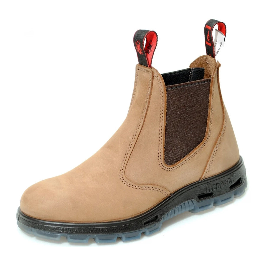 Side view of a Redback UBCH soft toe dealer boot in light tan nubuck leather featuring dark elastic side panels and red-accented pull tabs.