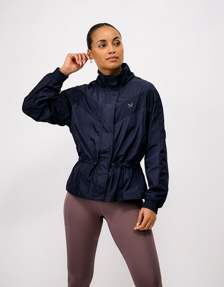 Crew Clothing Hooded Windbreaker Jacket featuring a breathable mesh lining, removable hood, adjustable drawcord waist, and silver reflective crossed oars on the chest.