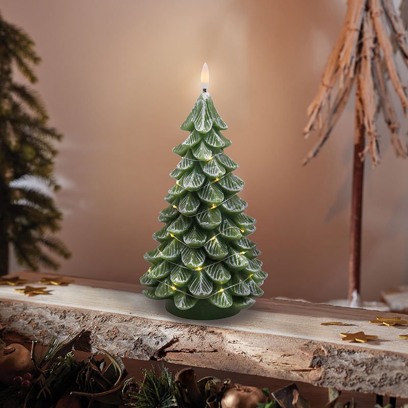 Smart Garden Christmas Tree LED candle with real wax casing glowing on a mantel.
