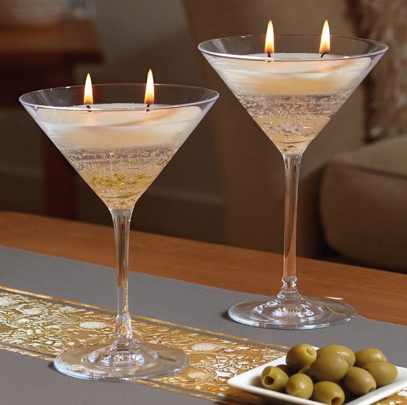Smart Garden Santé martini candle in gold filled with real wax and double wicks lit on a table