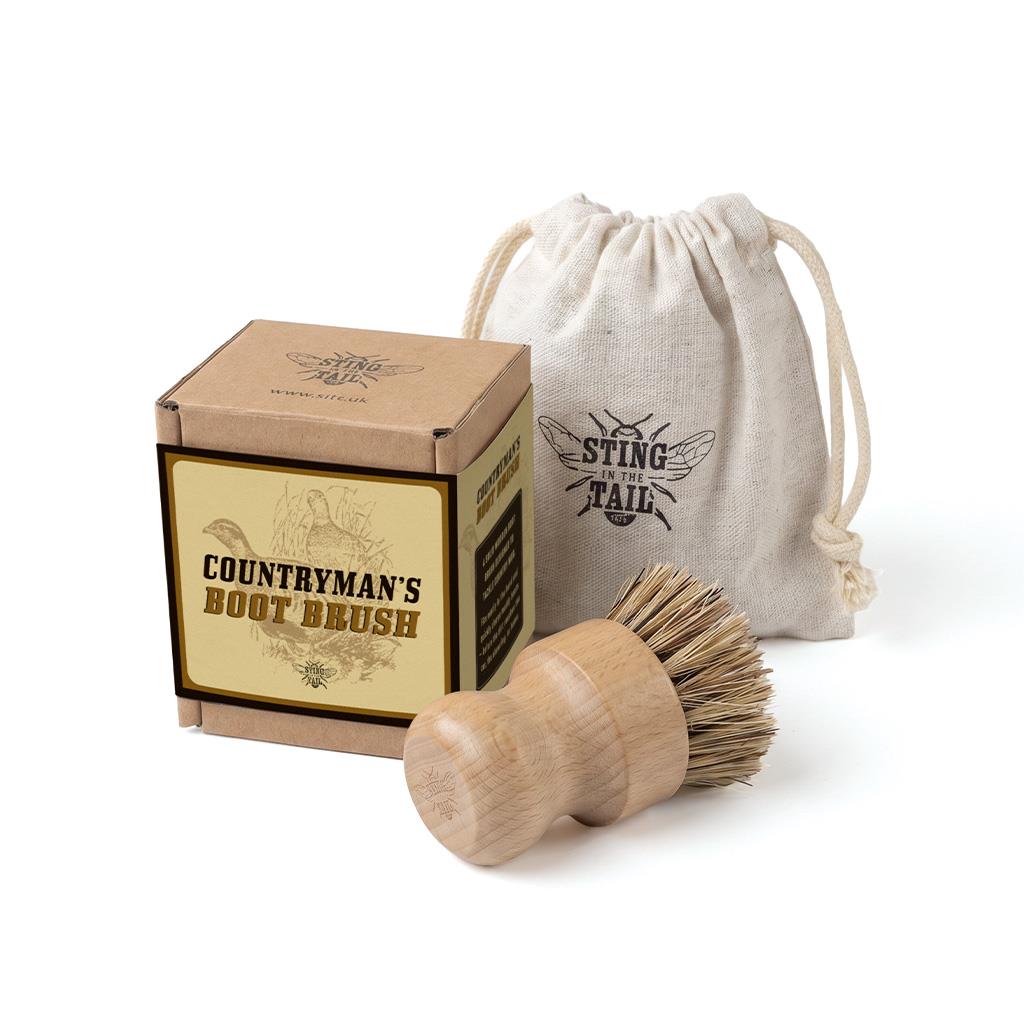 Sting in the Tail Countryman's Boot Brush with wooden handle, stiff bristles, drawstring pouch, and box.