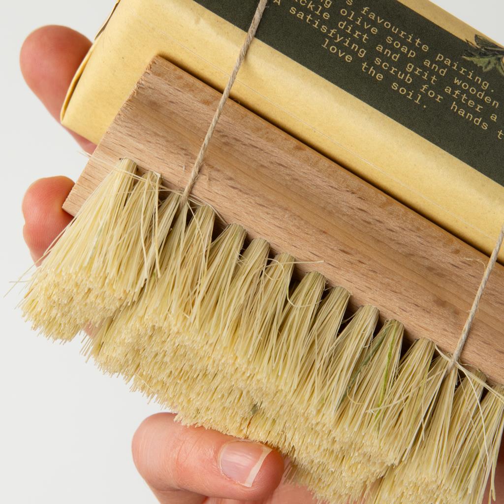 Sting in the Tail Gardener's Exfoliating Soap bar wrapped with a wooden nail brush using natural string.