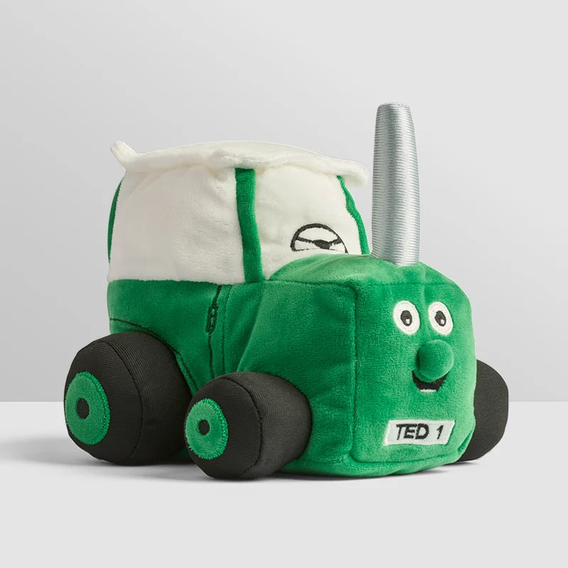 Soft green Tractor Ted plush toy sitting upright with embroidered details