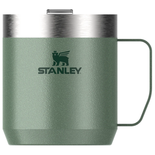 Stanley Legendary Everyday Camp Mug 350ml in Hammertone Green with secure Tritan drink-through lid on a rustic outdoor surface.
