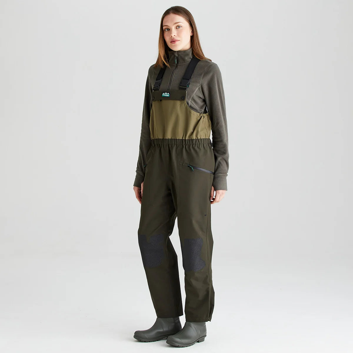 Ridgeline Women's Agri Pro Bib and Brace in action with adjustable braces and reinforced knee patches.