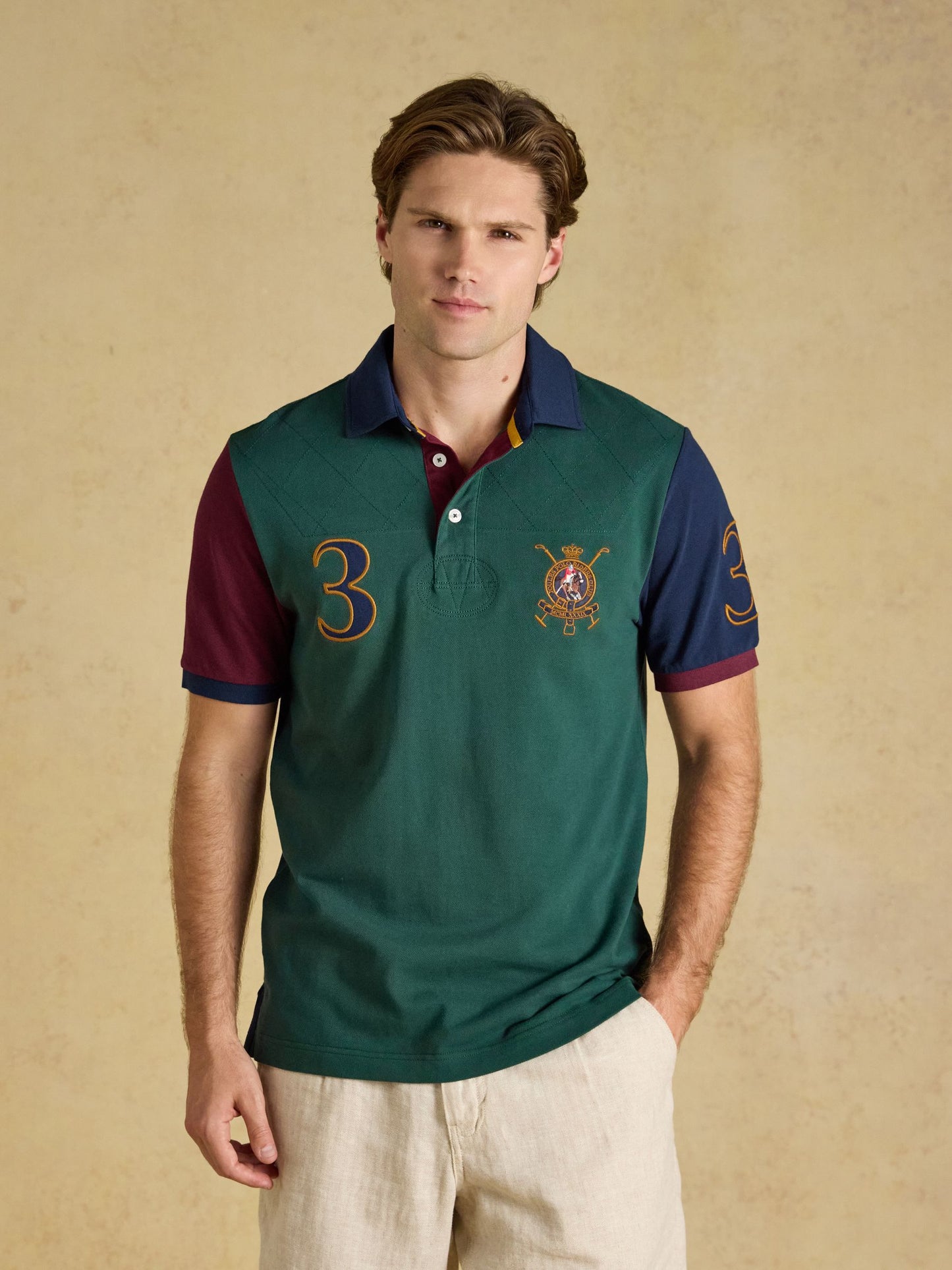 Joules Woody Embellished Cotton Pique Polo Shirt with bold applique detail and ribbed collar.