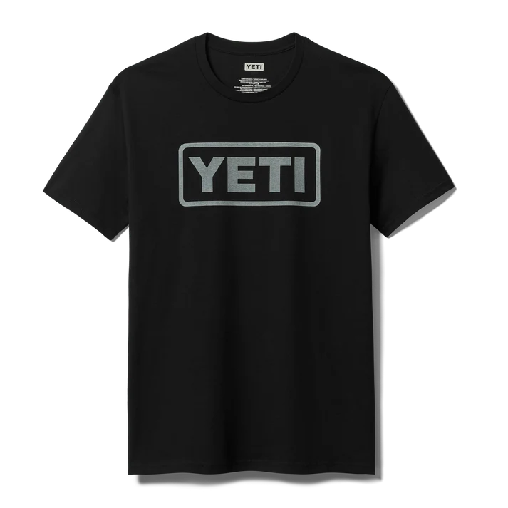 Men wearing YETI Full Logo Badge Short Sleeve T-Shirt in grey and black featuring front printed YETI badge logo