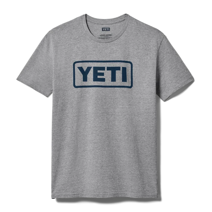 Men wearing YETI Full Logo Badge Short Sleeve T-Shirt in grey and black featuring front printed YETI badge logo