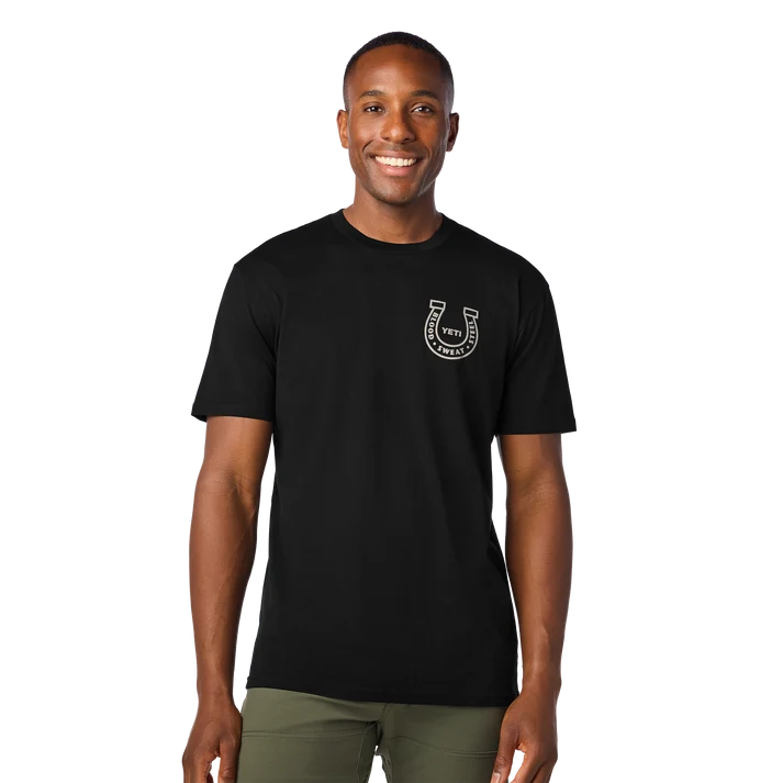 black YETI Horseshoe short sleeve t-shirt showing the white horseshoe graphic emblem on the left chest