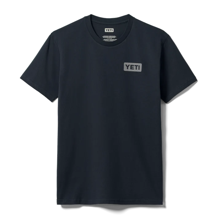 Front and back view of man wearing dark navy YETI short sleeve t-shirt with subtle left chest logo badge