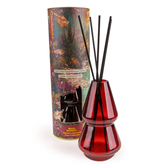 Candlelight River Blossom 150ml reed diffuser in red glass vessel beside illustrated presentation tube