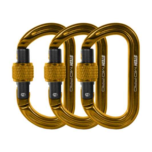 Three gold anodised STEIN MIO-Pro Mini-O compact oval screwgate connectors with black gates and keylock noses, displayed side by side.